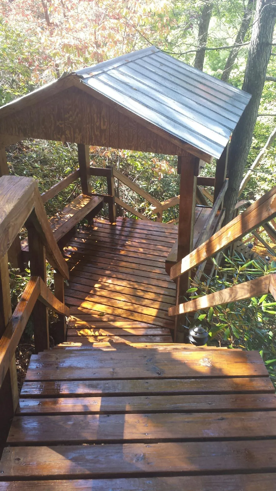 Freshly stained wood walkway and covered shelter with a metal roof in Bradenton Beach